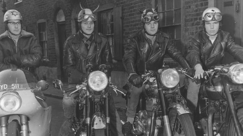 Four people riding motorcycles