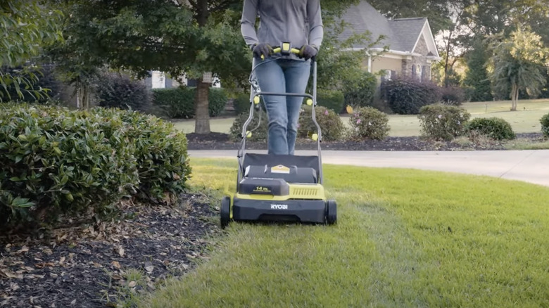 Person using Ryobi's Dethatcher/Aerator