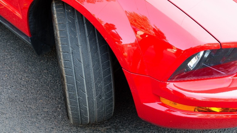 Red S197 Mustang with the front wheel splayed out