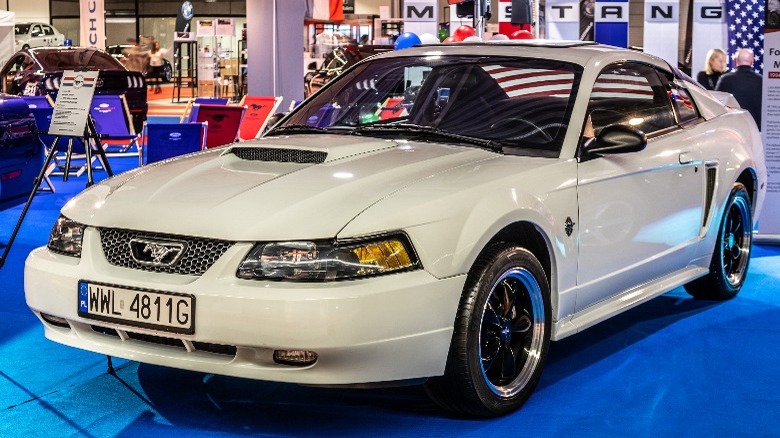 A white New Edge Mustang in a showroom