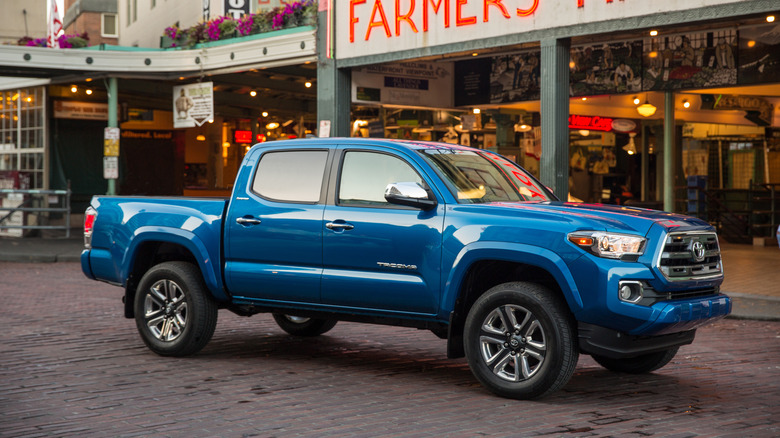 Blue 2016 Toyota Tacoma in front of farmers market