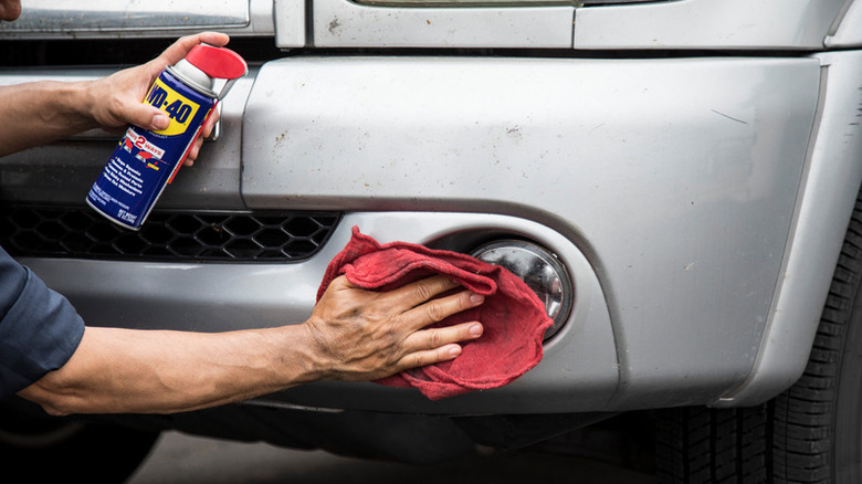 WD-40 being used on headlights