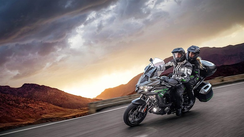 Two people ride Kawasaki Versys 1000 S