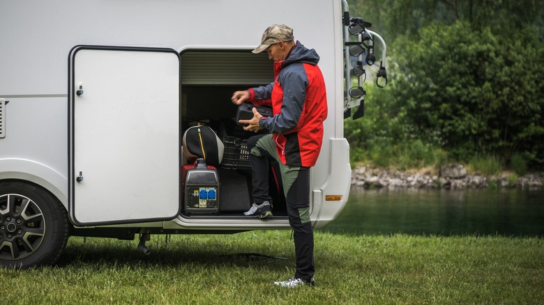 man unloading camper storage 