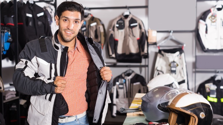 man tries on motorcycle jacket