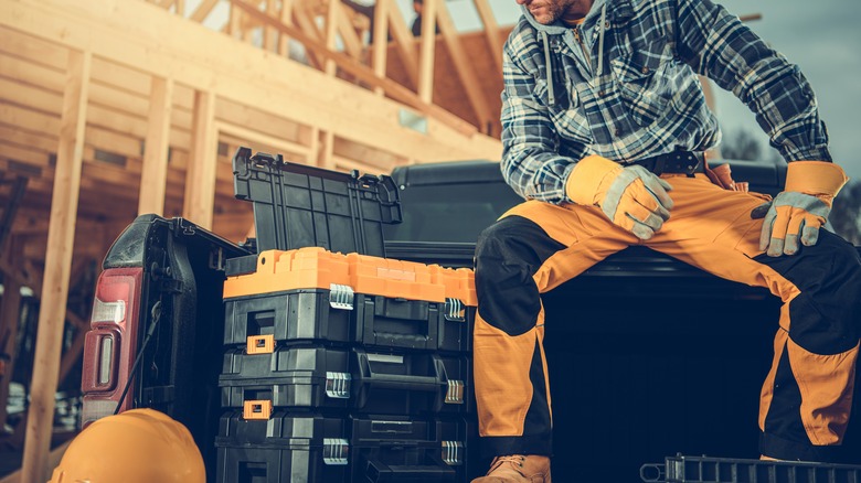 man sitting with tool boxes