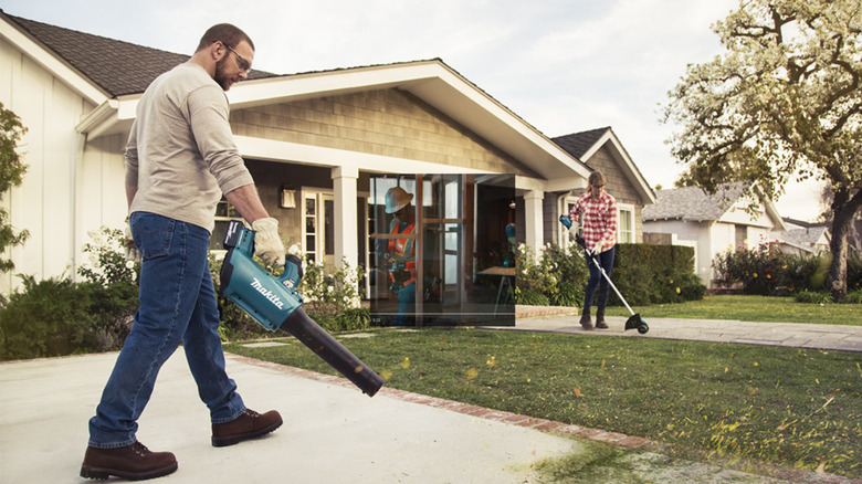 Two people doing yard work with Makita tools