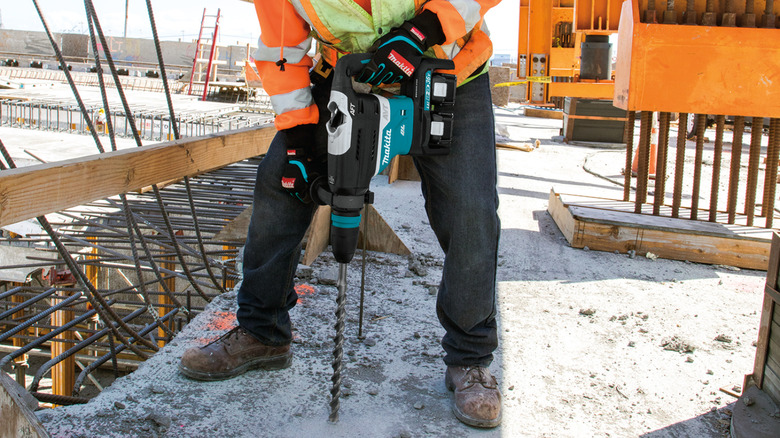 Man drilling into concrete with a rotary hammer