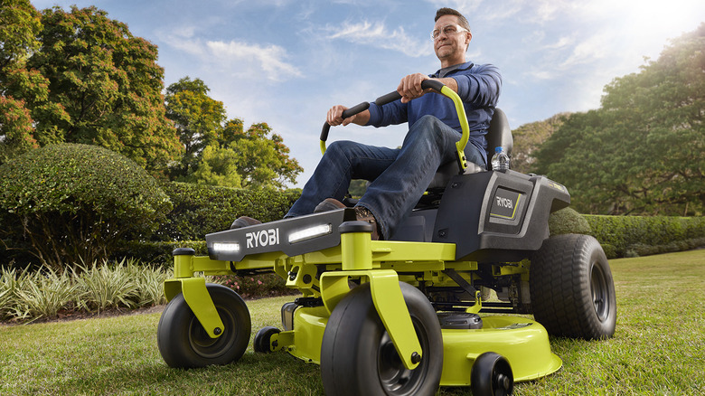 man riding Ryobi 42" 100 AH Zero Turn Electric Riding Lawn Mower