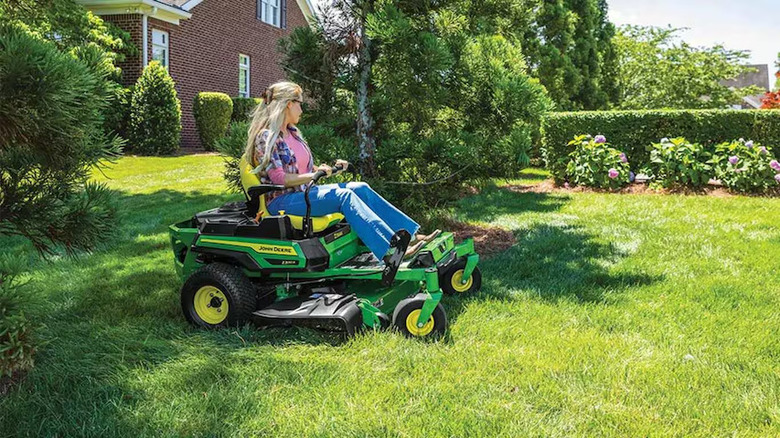 woman using 42-inch John Deere riding lawn mower