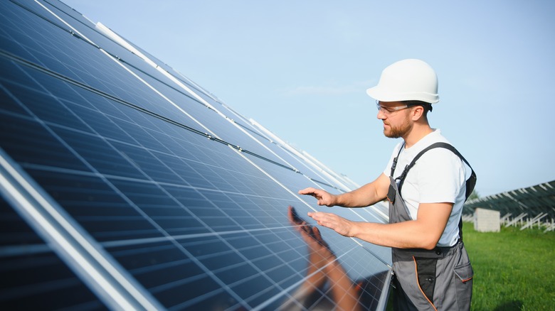 Man installing solar panel array