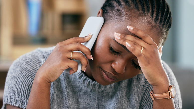 A woman on the phone looking frustrated