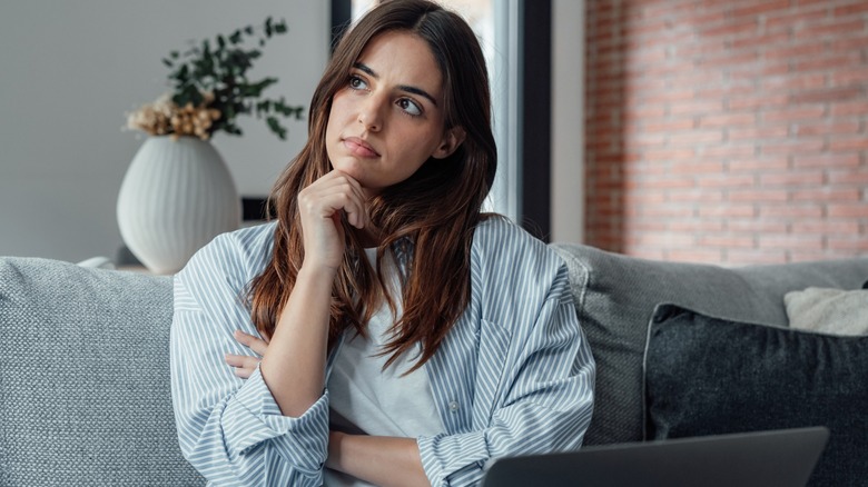 Woman looking away in deep thought