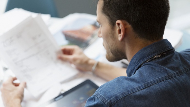 Over the shoulder shot of a man reviewing some documents