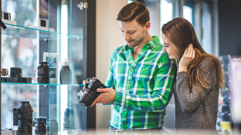 A man and woman looking to purchase a camera