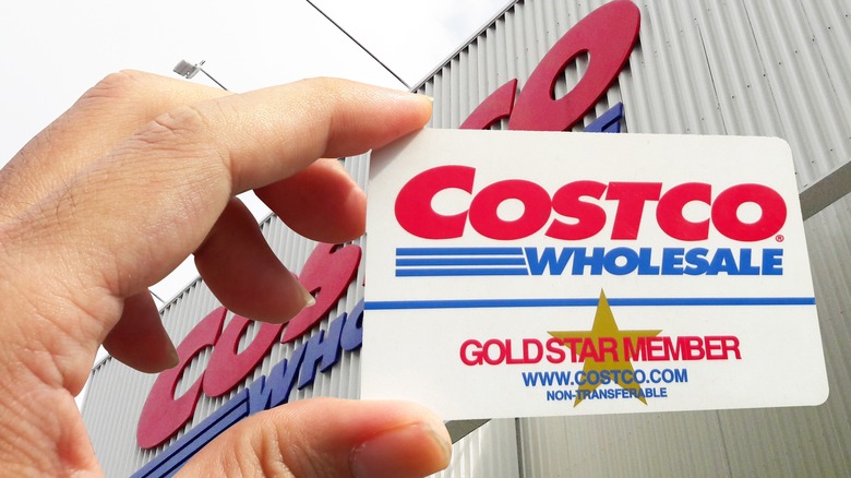 person holding costco membership card