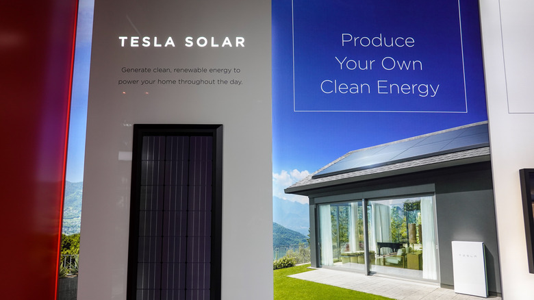 Tesla solar with a house in the background 