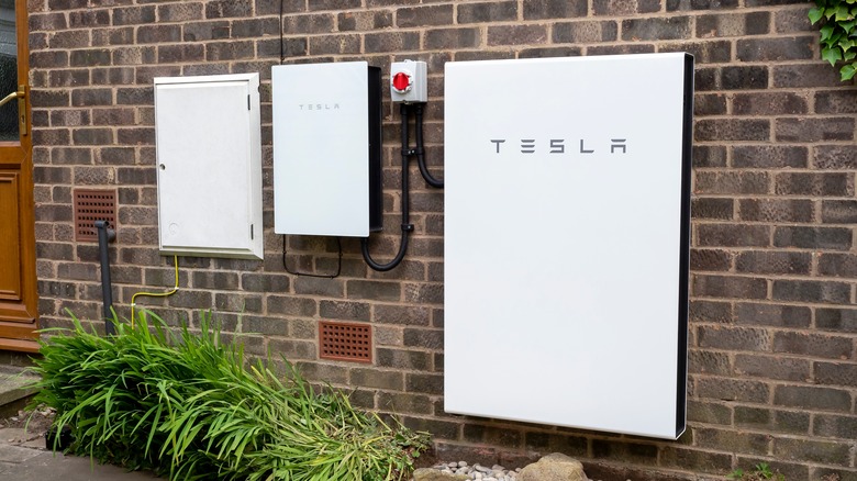 Tesla Powerwall installed on brick wall 