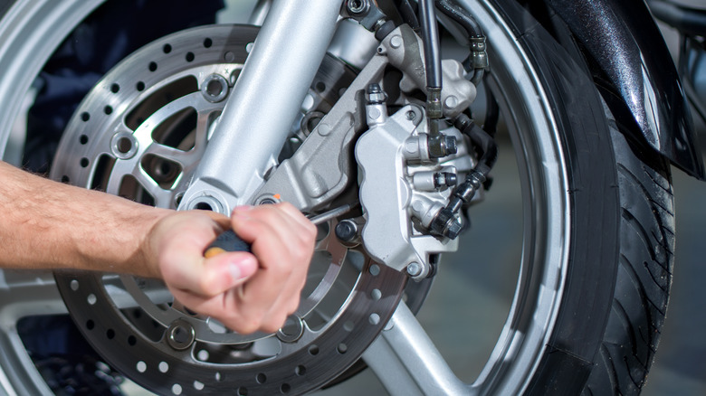 person repairing motorcycle tires