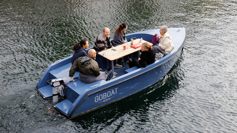 group sitting in electric boat