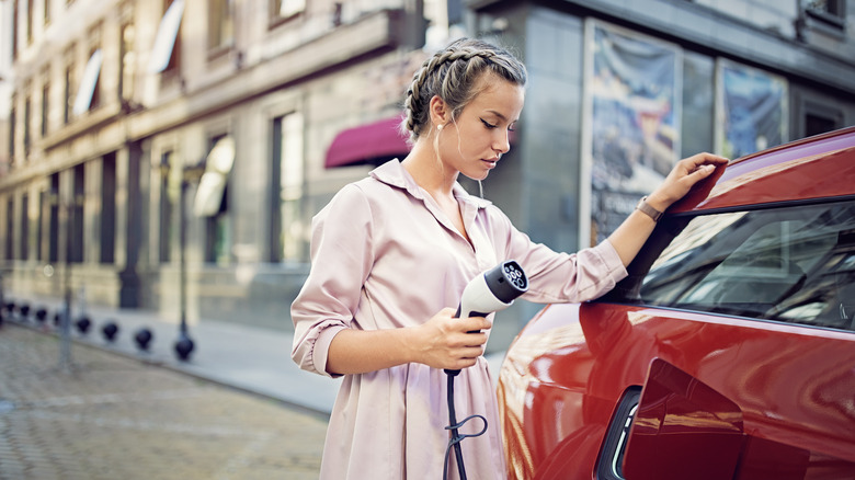 woman charging an electric car