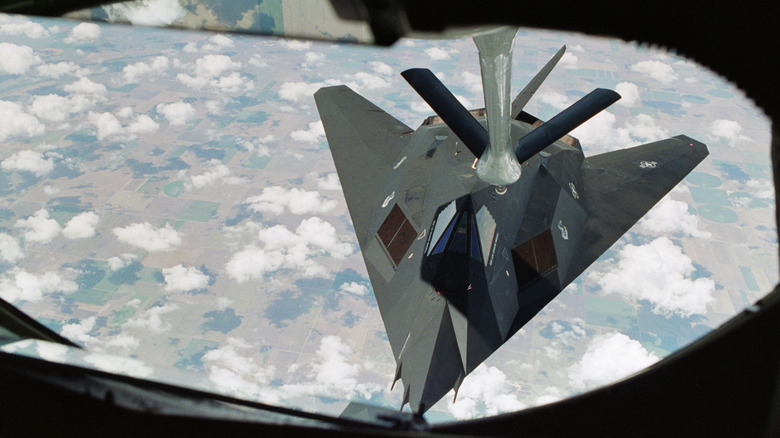 An aerial view of the F-117 stealth fighter flying above the clouds