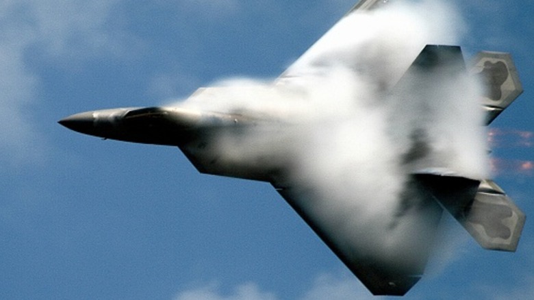 An F-22 covered in water vapor.