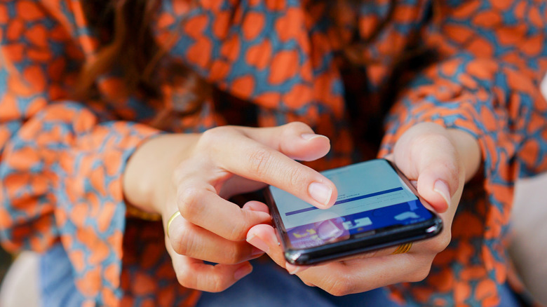 Woman using Facebook app