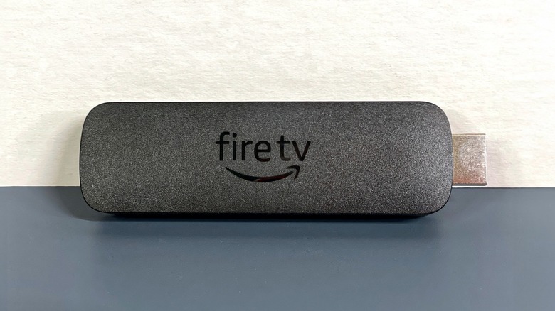 Fire TV Stick 4K Max (2nd Gen) plugged into the back of a TV