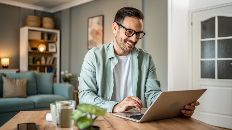 smiling person on laptop