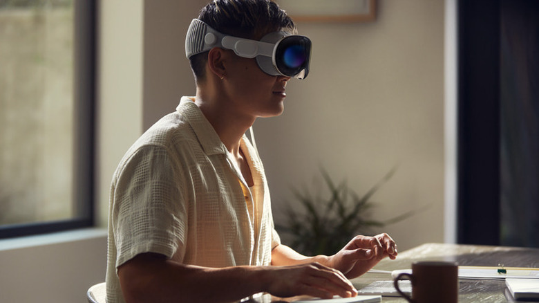 Person using Apple Vision Pro at desk