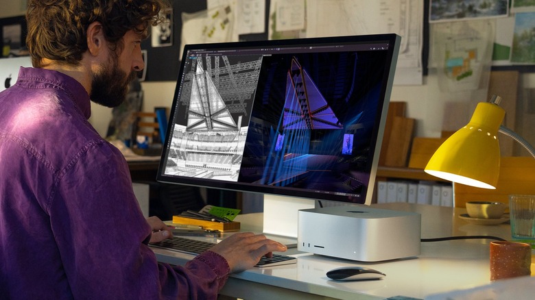 Man at desk with Mac Studio and Studio Display