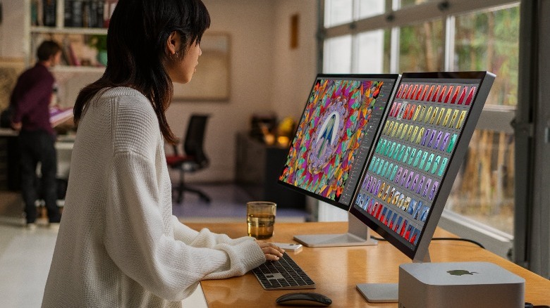 Person at desk with Apple Studio Displays