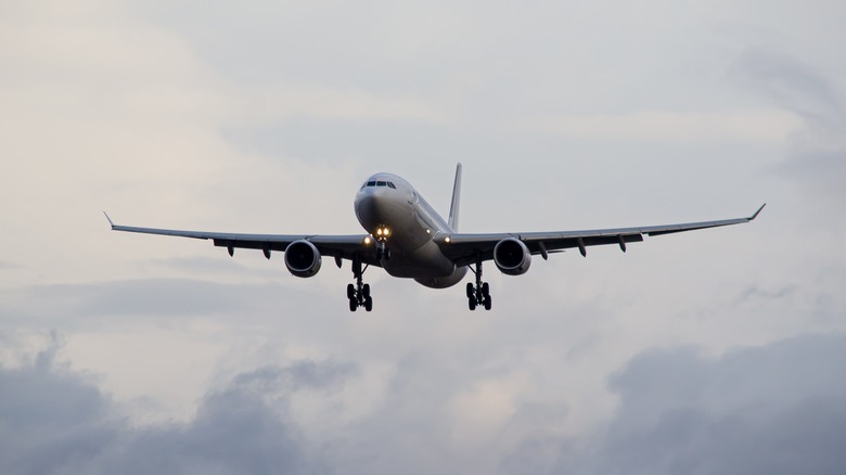 Aircraft flying through cloudy sky