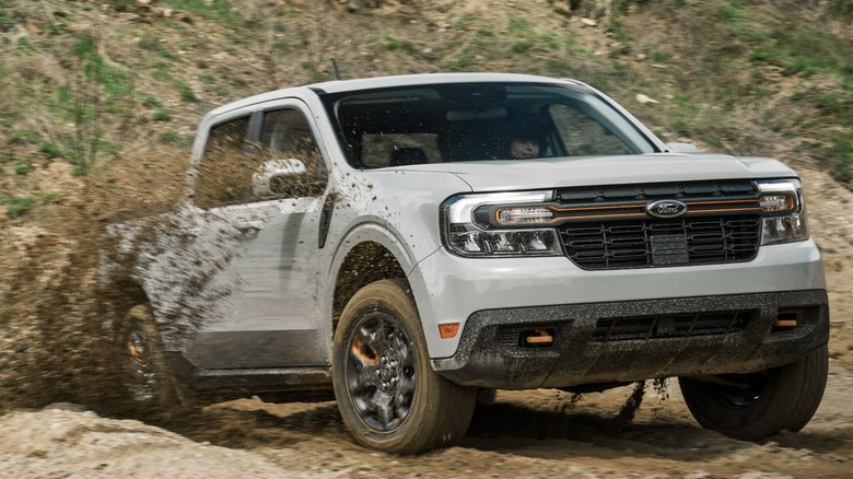 A Ford Maverick Tremor driving in the mud.