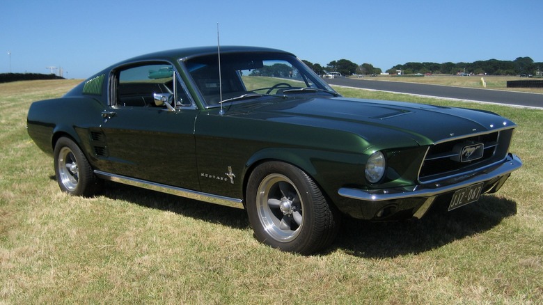 Dark green 1967 Ford Mustang fastback parked on grass