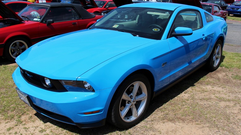 Blue 2010 Ford Mustang parked on grass