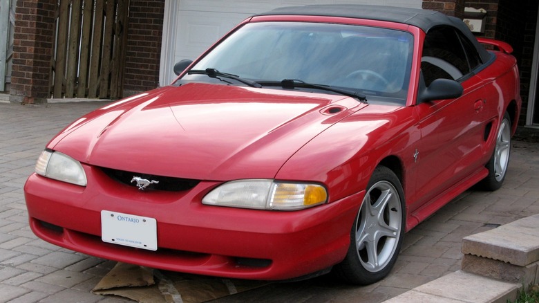 Red 1995 Ford Mustang convertible parked