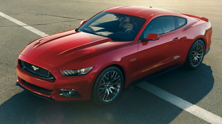 Red 2015 Ford Mustang parked on asphalt