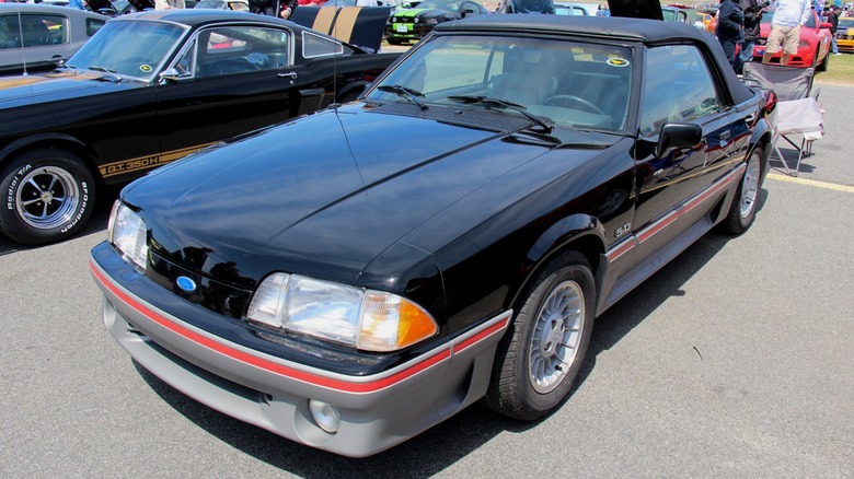 Black 1988 Ford Mustang GT convertible parked at a car show