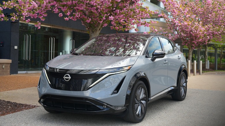 Nissan Ariya parked under cherry blossoms