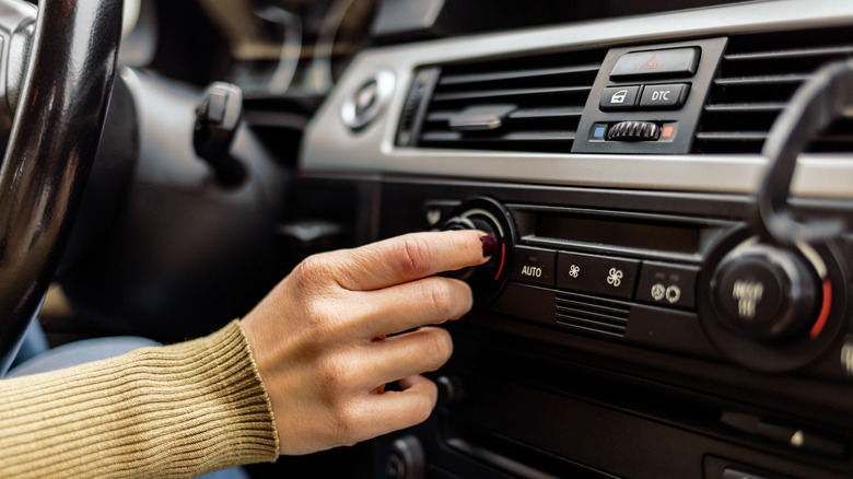 woman tuning car radio