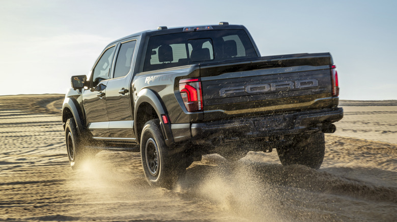 Ford F-150 Raptor driving over sand