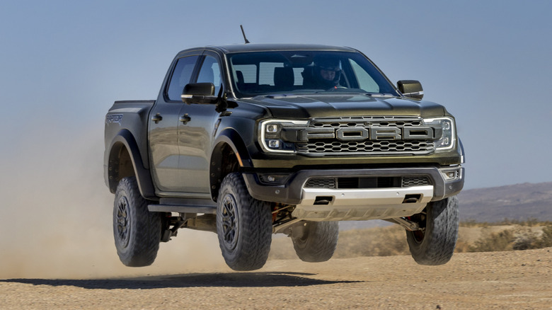 Ford Ranger Raptor jumping over sand/dirt