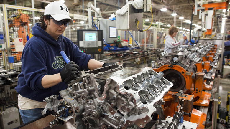 Ford employee working on an engine