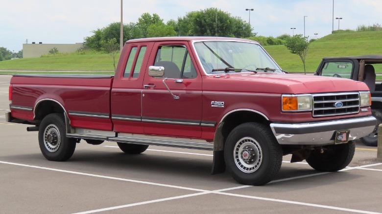 Red 1990 Ford F-250 pickup truck parked in parking lot