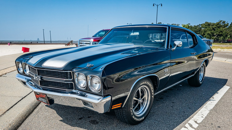 Black chevelle SS with silver racing stripes parked in parking lot