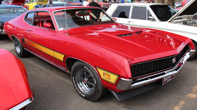 A parked red 1970 Ford Torino GT with a sportsroof