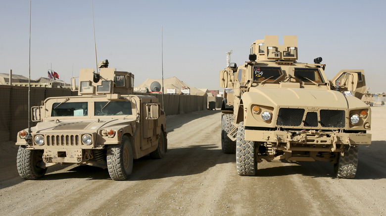 Humvee parked next to an MRAP