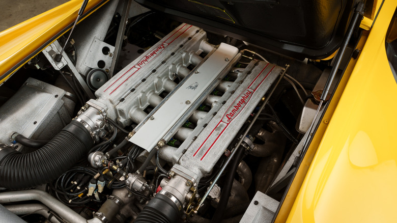 Engine bay of a yellow mid-engine Lamborghini Diablo